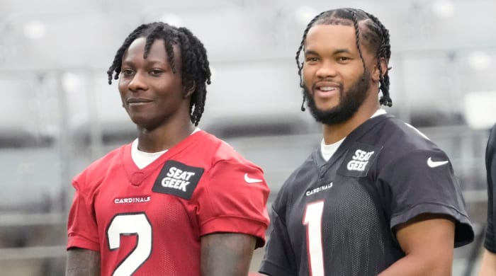 Aug 8, 2022; Glendale, Arizona, U.S.; Arizona Cardinals wide receiver Marquise Brown (2) and quarterback Kyler Murray (1) watch during training camp at State Farm Stadium.